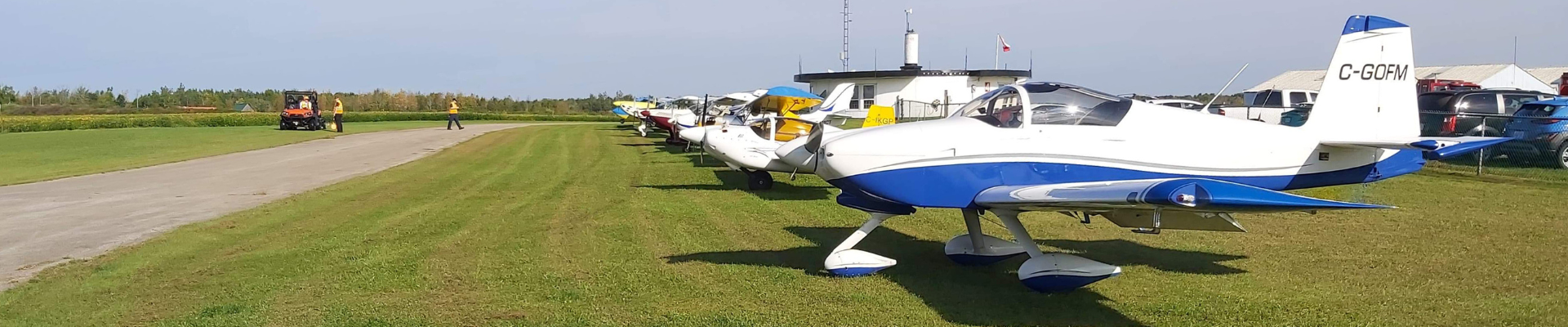 Personal aircraft line up in a row on the grass at the Brockville Airport