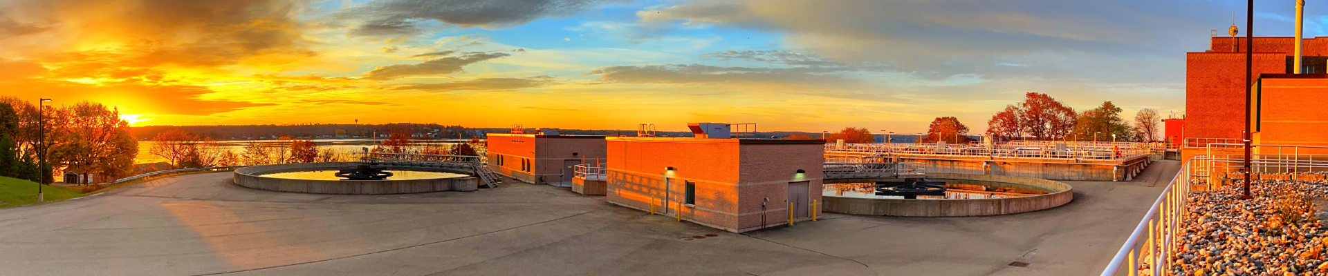 Brockville Wastewater facility beside the river at sunrise and lit up with orange morning light